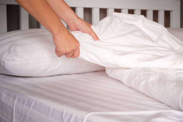 The hands of housewives who are changing sheets in hotels