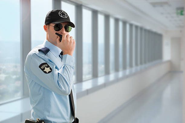 Security guard is talking with walkie talkie 